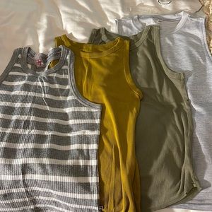 Four tank tops. Mountain hardware, brand new day, Adidas. Fit is M/L